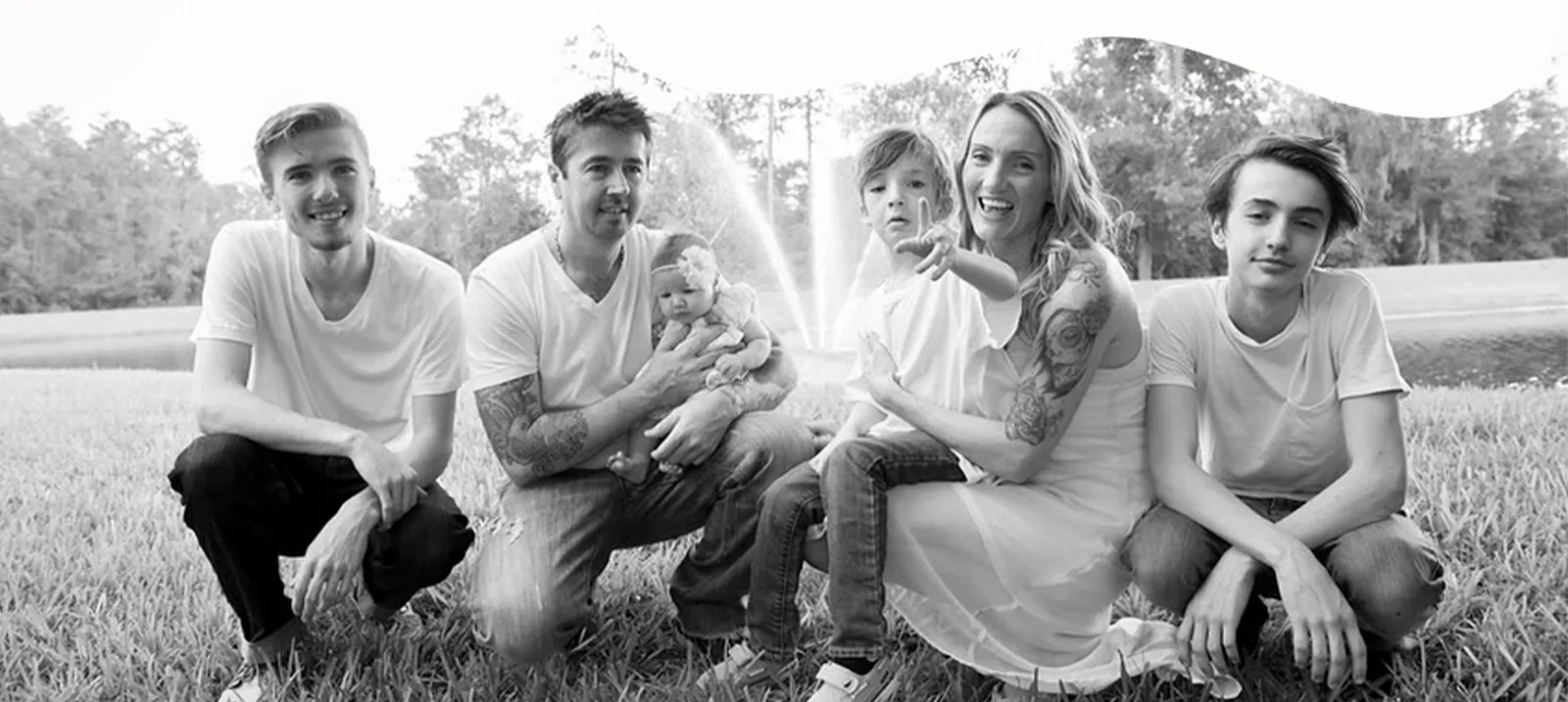 The Millie Moo's family together in a field — Danny and Kelly with their boys and baby Millie